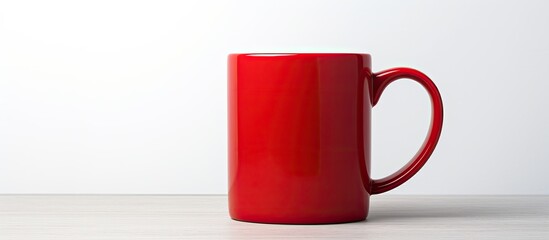 A red mug placed alone on a white background serves as a versatile copy space image for showcasing various designs and branding options