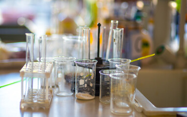 Flasks and test tubes with multi-colored chemical liquids in a laboratory in a clinic. Testing, analysis and research in laboratories. Clinical study.
