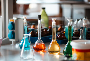 Flasks and test tubes with multi-colored chemical liquids in a laboratory in a clinic. Testing,...