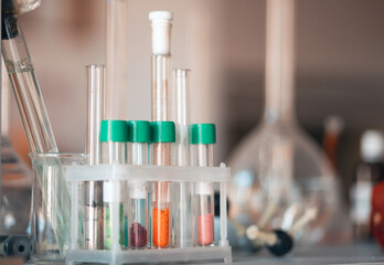 Flasks and test tubes with multi-colored chemical liquids in a laboratory in a clinic. Testing, analysis and research in laboratories. Clinical study.
