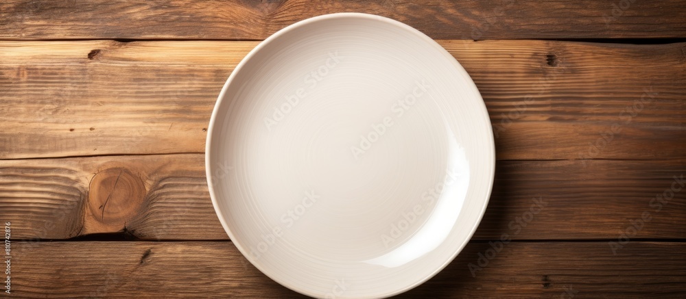 Canvas Prints Top view of an empty plate displayed on a wooden surface with ample copy space for images