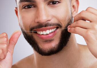Studio, portrait and man with floss, smile and dental care with confidence, protection and...