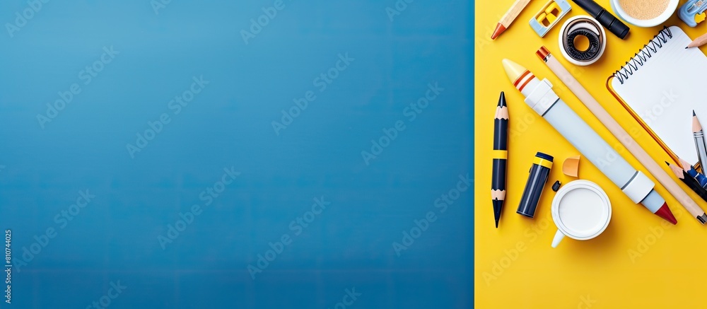Leinwandbilder The back to school theme features white and yellow school tools and a rocket on a blue background The objects are arranged in a flat lay style with a top view and there is ample copy space available