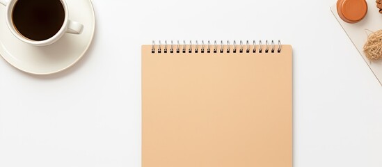 Cream background with top view of workbook and stationary mockups including copy space image