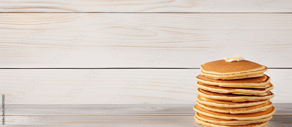 Poster Top view of a stack of pancakes displayed on a white wooden table creating a visually appealing copy space image