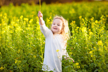 Child in spring park with flowers