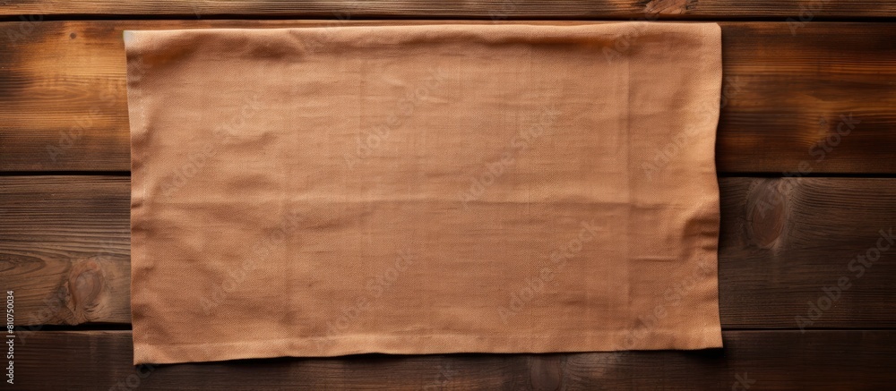 Poster copy space image of a cloth napkin resting on a rustic wooden surface creating an inviting backdrop 