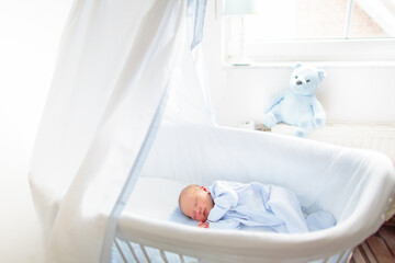 Baby in a white crib. Child in bed.