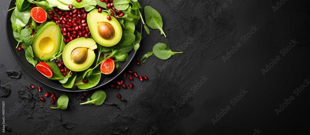 Poster top view of a visually appealing avocado salad featuring baby spinach and pomegranate presented on a
