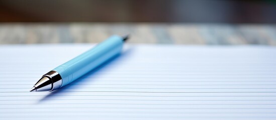 A pen is pictured up close on a blank sheet of paper providing ample copy space for written content