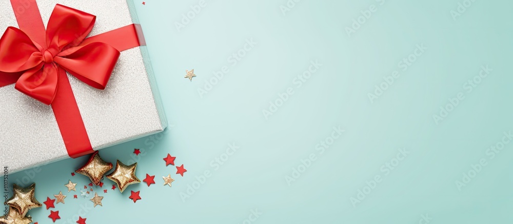 Poster Top view of a light blue background with a Christmas gift ribbons and ample space for text creating a visually pleasing copy space image
