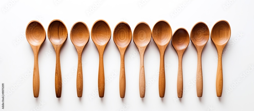 Poster A simple and clean image showcasing wooden spoons on a white background with plenty of copy space