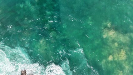 Aerial view of the ocean and clear blue water 