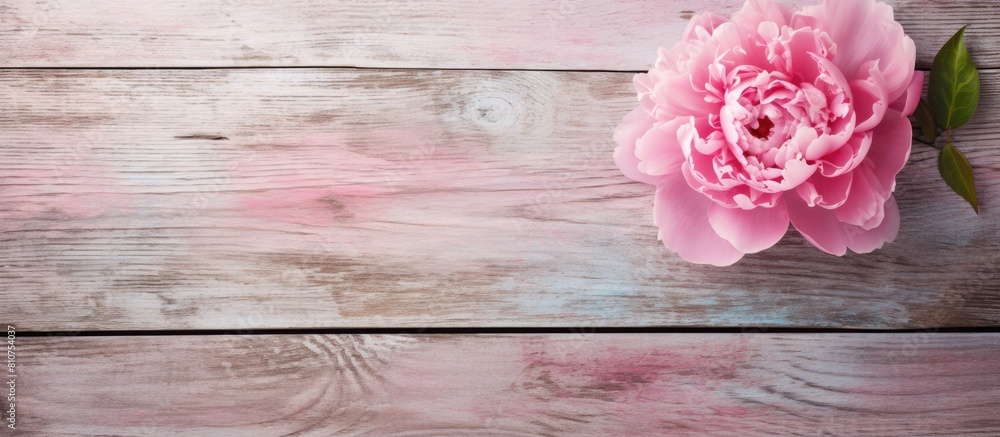 Aufkleber top view of an old grunge painted board with a pink peony and a heart carved in wood creating a styl