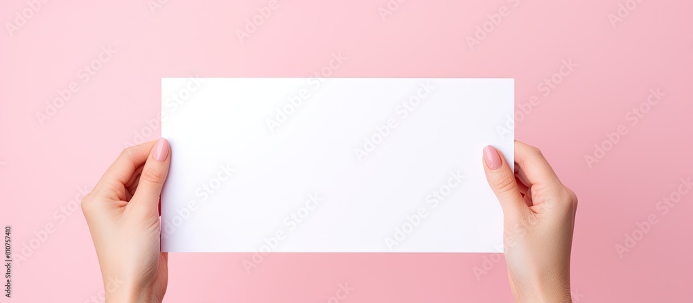 Leinwandbilder a close up image of a woman holding a pink blank paper against a white background the image offers a