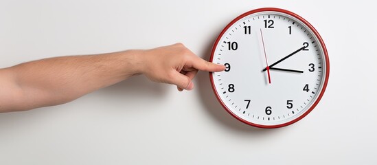 A hand holds a wall clock against a white background creating a visually appealing copy space image