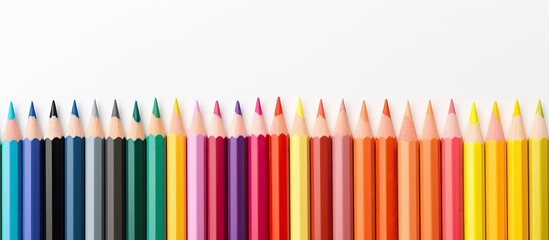 A copy space image of color pencils placed on a white background leaving ample room inside for text