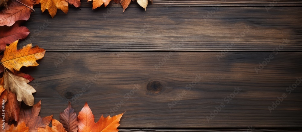 Poster a wood background with dried leaves arranged in a frame captures the essence of autumn the flat lay 