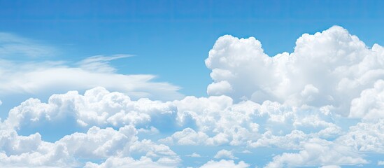 Beautiful white clouds floating in the clear blue sky creating a mesmerizing copy space image