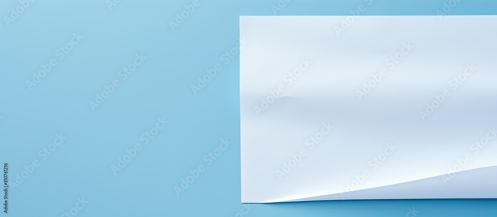 Fototapete a white sheet of paper is placed on a blue background providing ample copy space for text the image 
