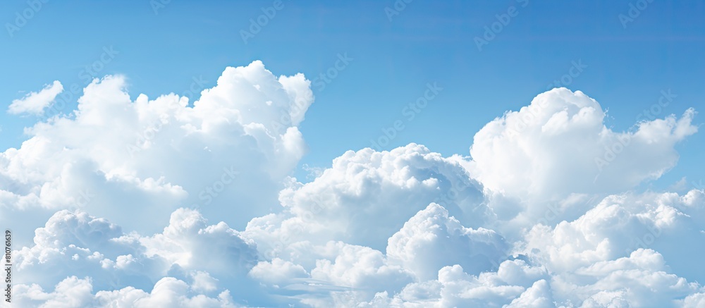 Poster A wide background with a blue sky and fluffy clouds perfect for a summer template or backdrop image with copy space