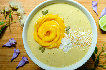 Mango pineapple smoothie bowl made with coconut milk mango pineapple and banana topped with mango...