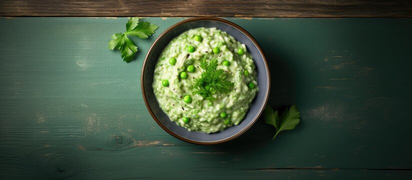 A bowl of homemade creamy green pea risotto photographed from above with plenty of space for text on the side. Creative banner. Copyspace image