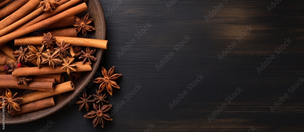 Aufkleber Top view of cinnamon sticks on a dark wooden background creating a captivating copy space image This condiment is perfect for making mulled wine