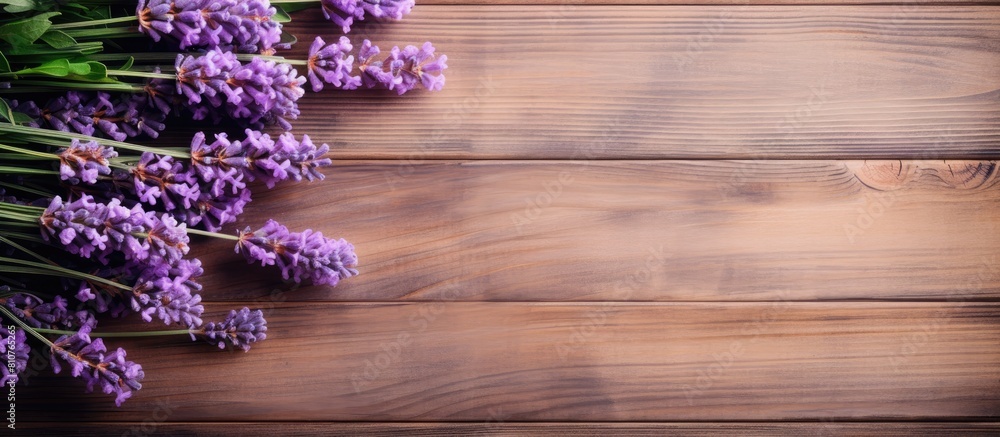Poster Top view of a bouquet of fresh lavender flowers on a wooden background creating a copy space image for your text