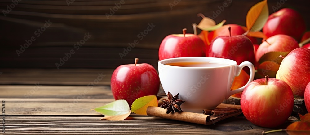 Poster autumn hot apple tea visually presented with ripe apples in a white cup on a wooden background perfe