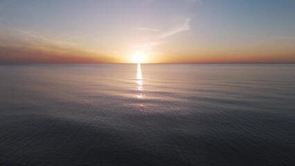 Aerial View of the Baltic Sea at Sunset, Jurkalne, Latvia. Beautiful Golden Sunset Over the Beach Seascape. Glittering Sunlight Reflection. The Baltic Sea at the Jurkalne Seashore Bluffs