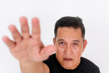 Modest man in a black shirt, reaching out with hand, overhead portrait