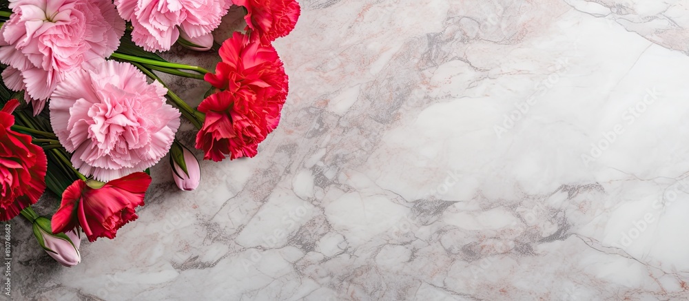 Poster top view of a stunning bouquet of pink and red carnations on a marble table this beautiful arrangeme