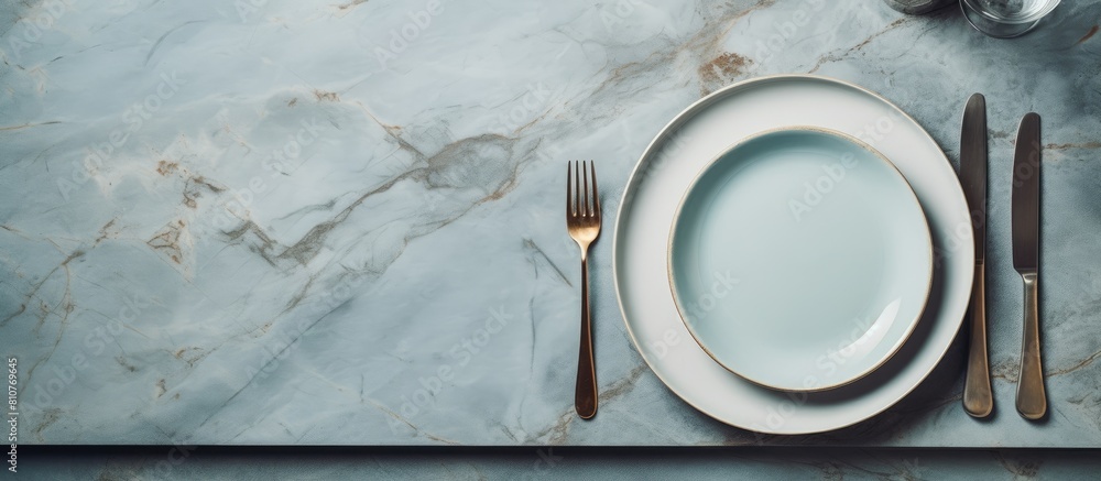 Poster a light grey marble table is shown in a flat lay style featuring an empty blue plate accompanied by 