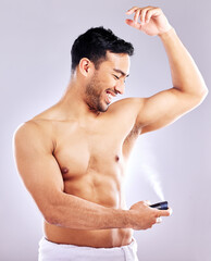 Man, grooming and smile with deodorant in studio background for hygiene, cleanliness and wellness....