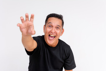 Middle-aged Asian man reaching out, isolated on white background, obsessed and eager expression