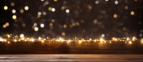 During Christmas time a copy space image shows rice lights twinkling on a wooden plank
