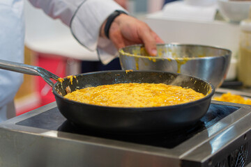Typical potato omelette. Professional cook in a professional kitchen preparing a potato omelette. Peaked potato omelette.