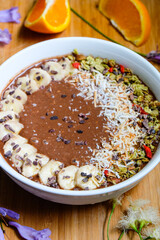  Healthy Raw Cacao chocolate smoothie bowl topping with cacao nibs and cacao granola goji berry banana and orange