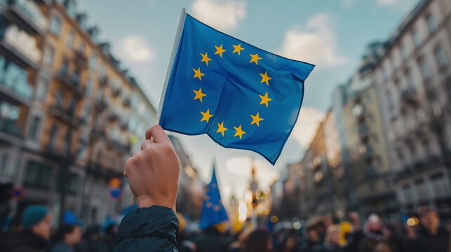 A man holds the European Union flag at the European Union Day celebration