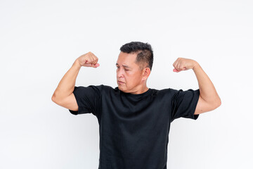 Confident middle-aged Asian man flexing biceps, isolated on white