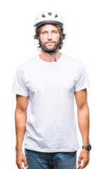 Handsome hispanic cyclist man wearing safety helmet over isolated background with serious expression on face. Simple and natural looking at the camera.