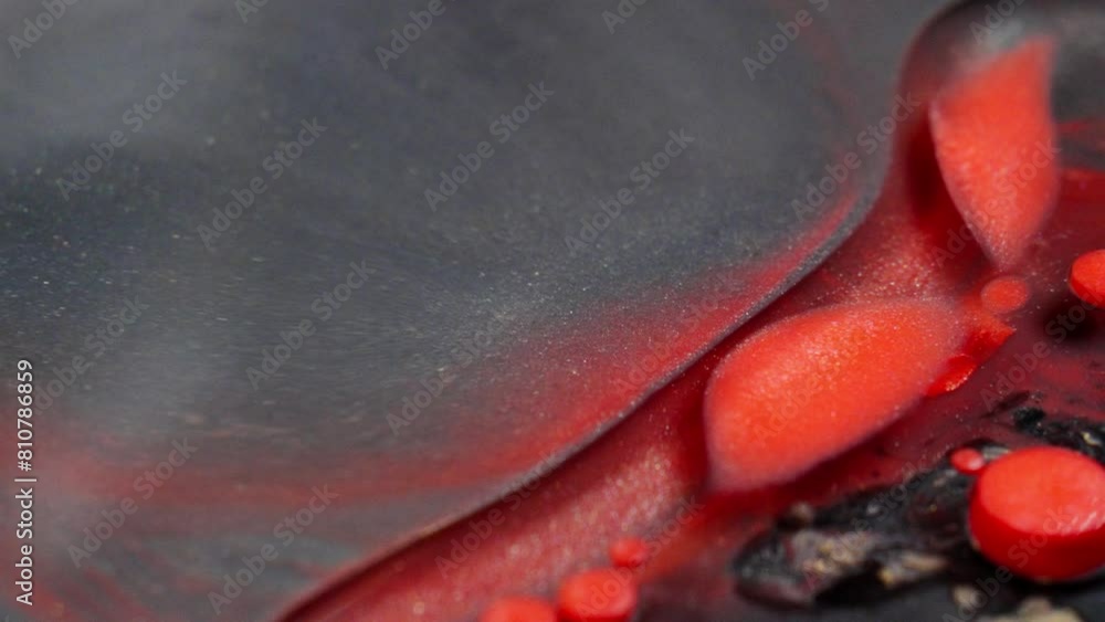 Poster close-up of vibrant red ink spreading organically through water creating abstract patterns