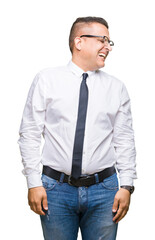 Middle age bussines arab man wearing glasses over isolated background looking away to side with smile on face, natural expression. Laughing confident.