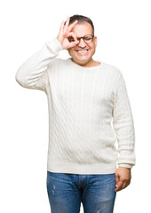 Middle age arab man wearing glasses over isolated background doing ok gesture with hand smiling, eye looking through fingers with happy face.