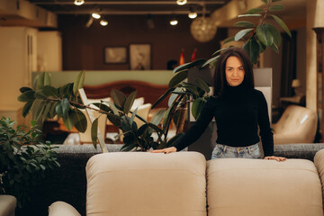 Caucasian woman shopping for furniture, recliner and home decor in store. Lady sitting on rocking chair imagining her new home architectural arrangement.