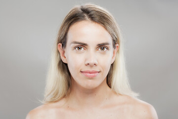 Portrait of a confident young woman with natural makeup and bare shoulders