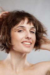 Fototapeta premium beauty portrait of a brunette girl with short hairstyle. hands in the hair