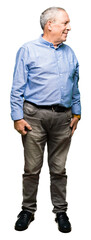 Obraz premium Handsome senior businesss man wearing elegant shirt looking away to side with smile on face, natural expression. Laughing confident.