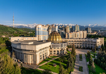 View from a quadcopter of the south-eastern part of the Kazakh city of Almaty against the backdrop of a mountain range on a sunny spring day